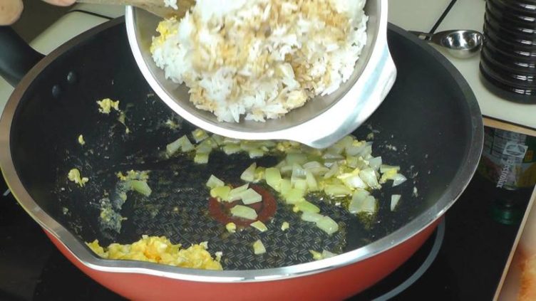 Image of adding rice to eggs & Onions