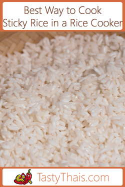 Photo of sticky rice cookd in a rice steamer with a bamboo basket