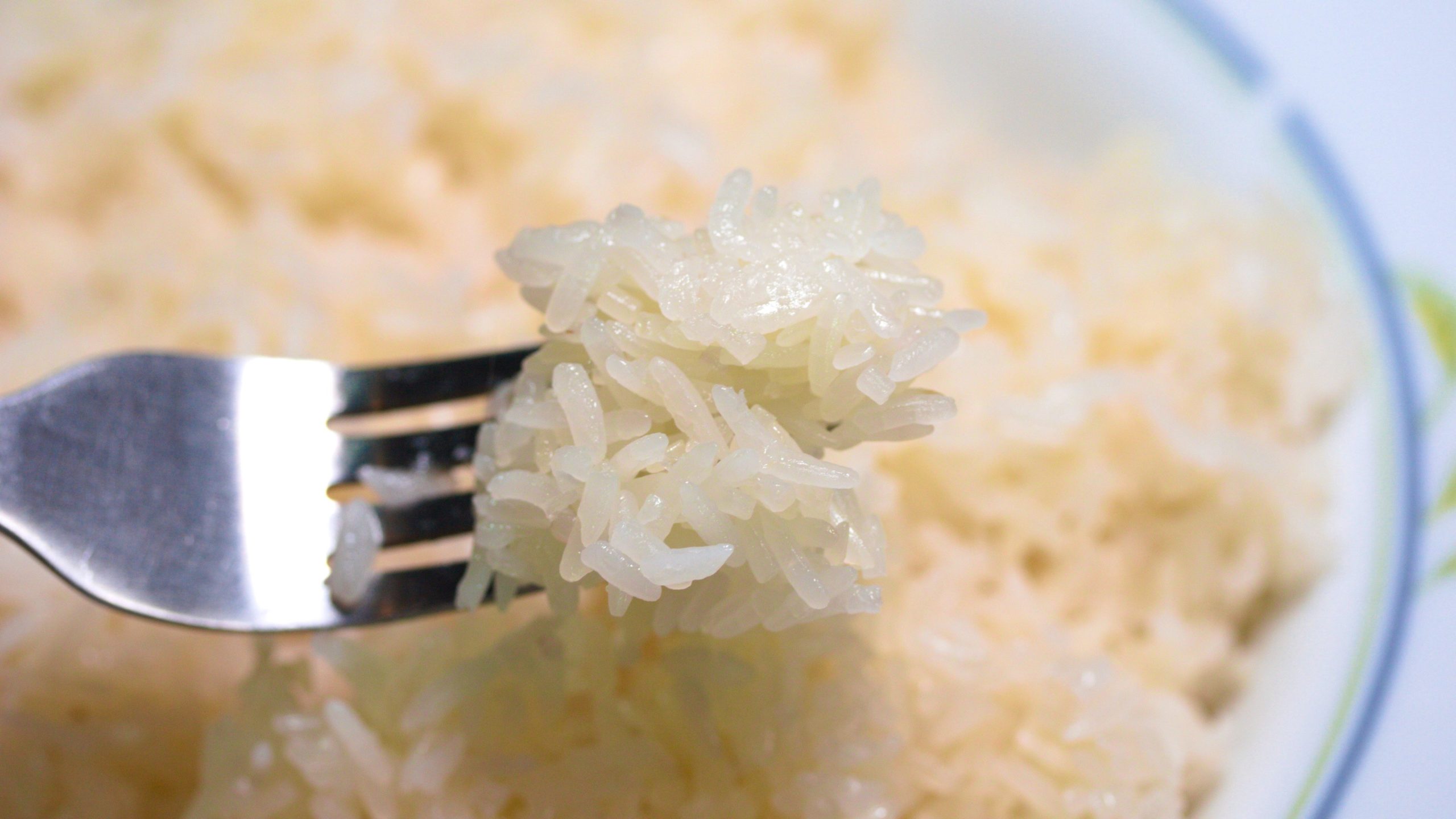 Hands cooking sticky rice with pot and rice steamer, traditional