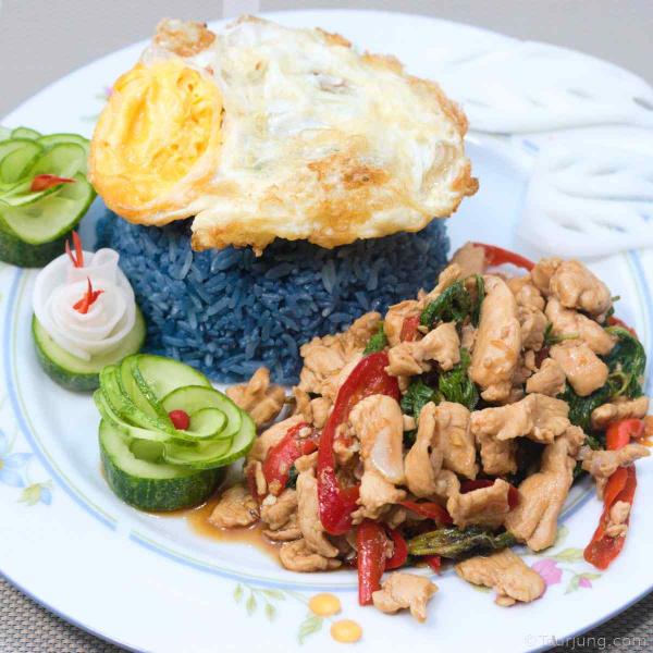 Easy Thai Chicken with Basil Recipe – Pad Krapow Gai Stir-Fry with Fried Egg photo of fun Pad Grapow Gai served with blue rice and fried egg