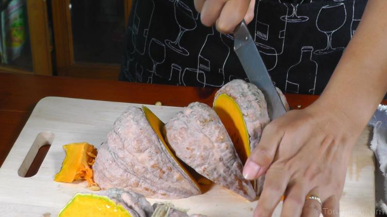 photo of pumpkin being cut before peeling