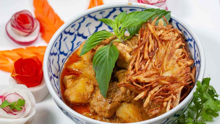 Photo of Thai Massaman Gai with potato nests and decorations