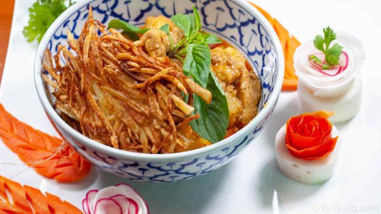 Photo of thai Massmana Chicken Curry featuring fried potato nests