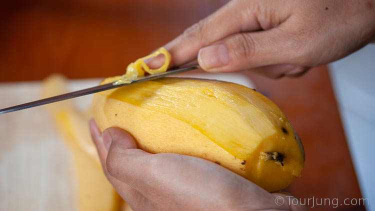 Easy Mango Sticky Rice Recipe - Authentic Mango with Sticky Rice & Coconut Milk Photo of Peeling the Mango