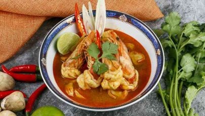 photo of Tom Yum Kung Soup in a blue serving bowl