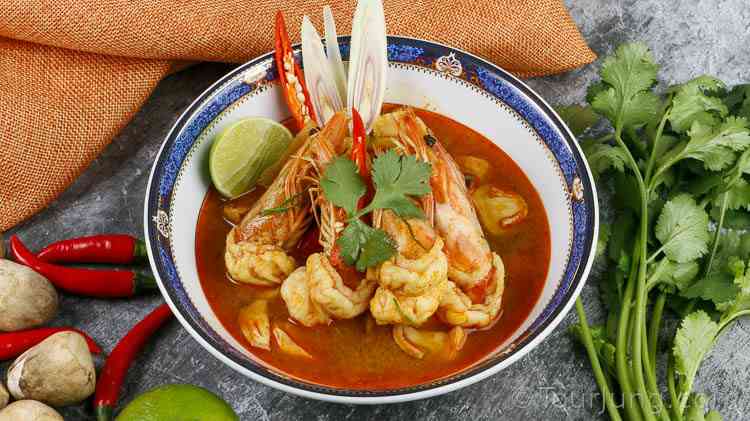 Easy Tom Yum Goong Recipe - Best Authentic Thai Hot & Sour Soup with Chili Paste (Nam Kon) photo of Tom Yum Kung Soup in a blue serving bowl
