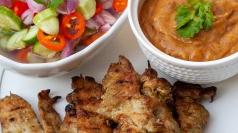 Awesome Thai Chicken Satay Skewers with Peanut Sauce Recipe - BBQ & Air Fryer Cooked Thai Street Food Photo of chicken satay skewers with peanut sauce & sweet pickles