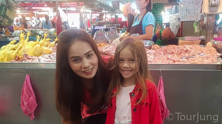 photo of Katie at the Local Thai market Buying Chicken for Green Curry