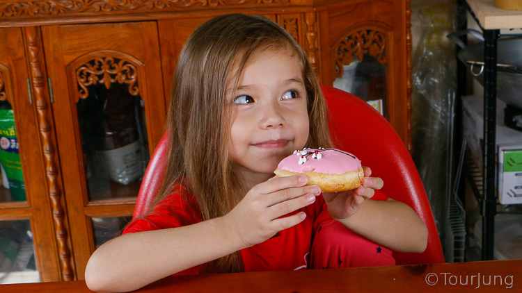 photo of Katie about to eat a donut after making wontons