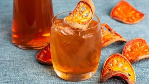 Photo of Iced Thai Bael Fruit Tea with Dried Bael in the foreground