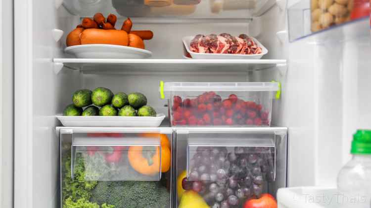 photo of full fridge where juices from raw produce can contaminate cooked food below