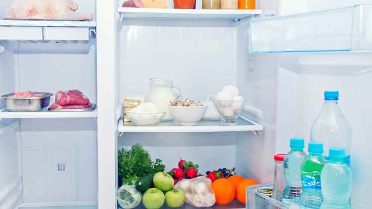 What Food to Stock Up On to Weather the Coronavirus Pandemic - Essentials photo of a fridge and freezer being defrosted and reloaded in preparation for long term food storage for self-isolation