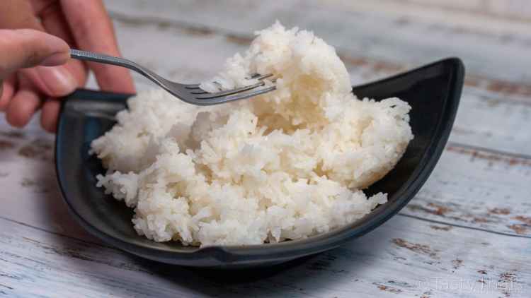 photo of microwaved rice on a black plate