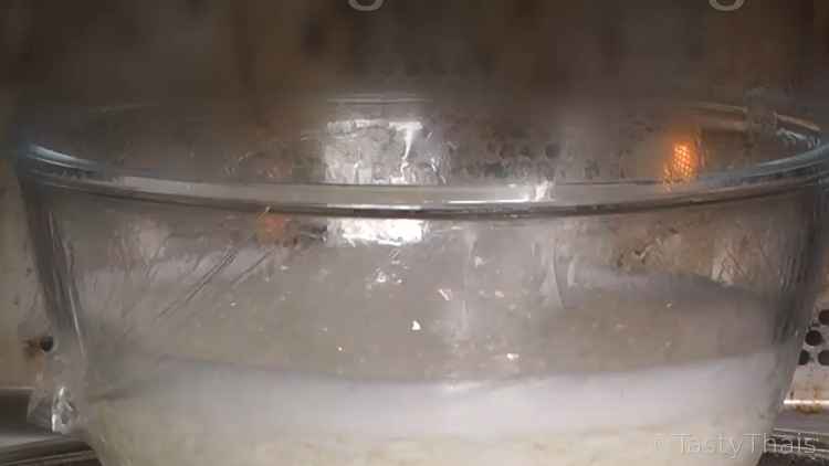photo of rice cooking in microwave with distended plastic wrap