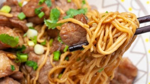 beautiful photo of stir fried pork with egg noodles dish served and close up