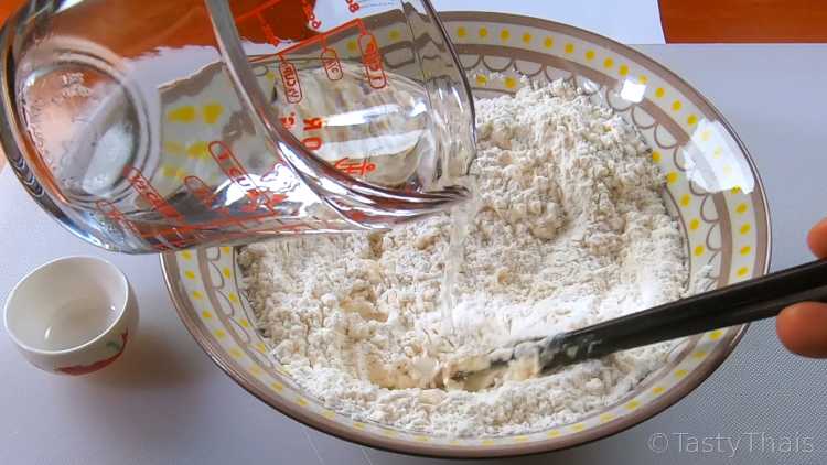 Making Gyoza wrappers, Pork Fillings & Frying Gyoza Dumplings Mixing flour and water for Gyoza
