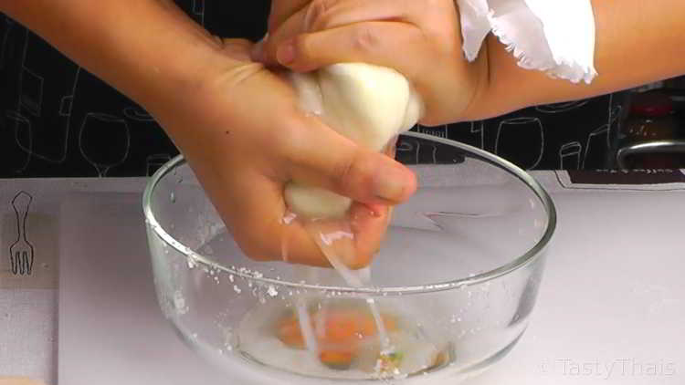 Wringing out the excess water from cauliflower before cooking for sushi filling