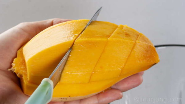 Peel the mango skin and fibrous underlayer too
