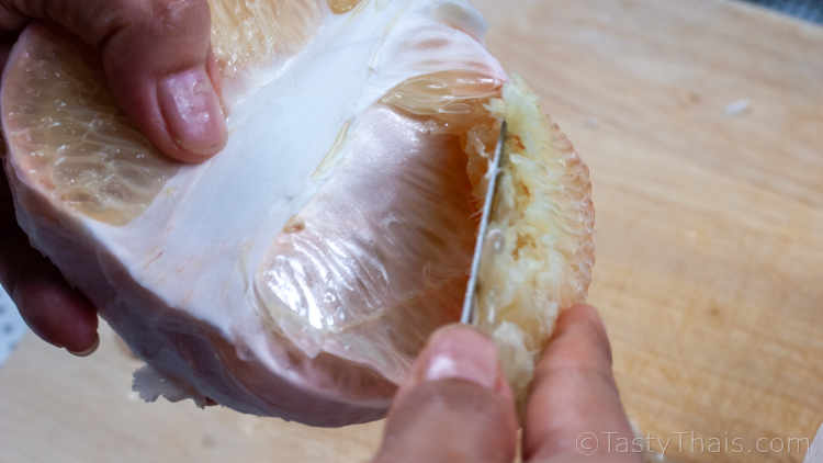 Separating the flesh from the pomelo membrane