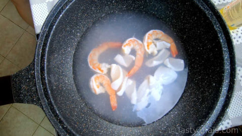 Part cooking the main protein ingredient - in this case seafood
